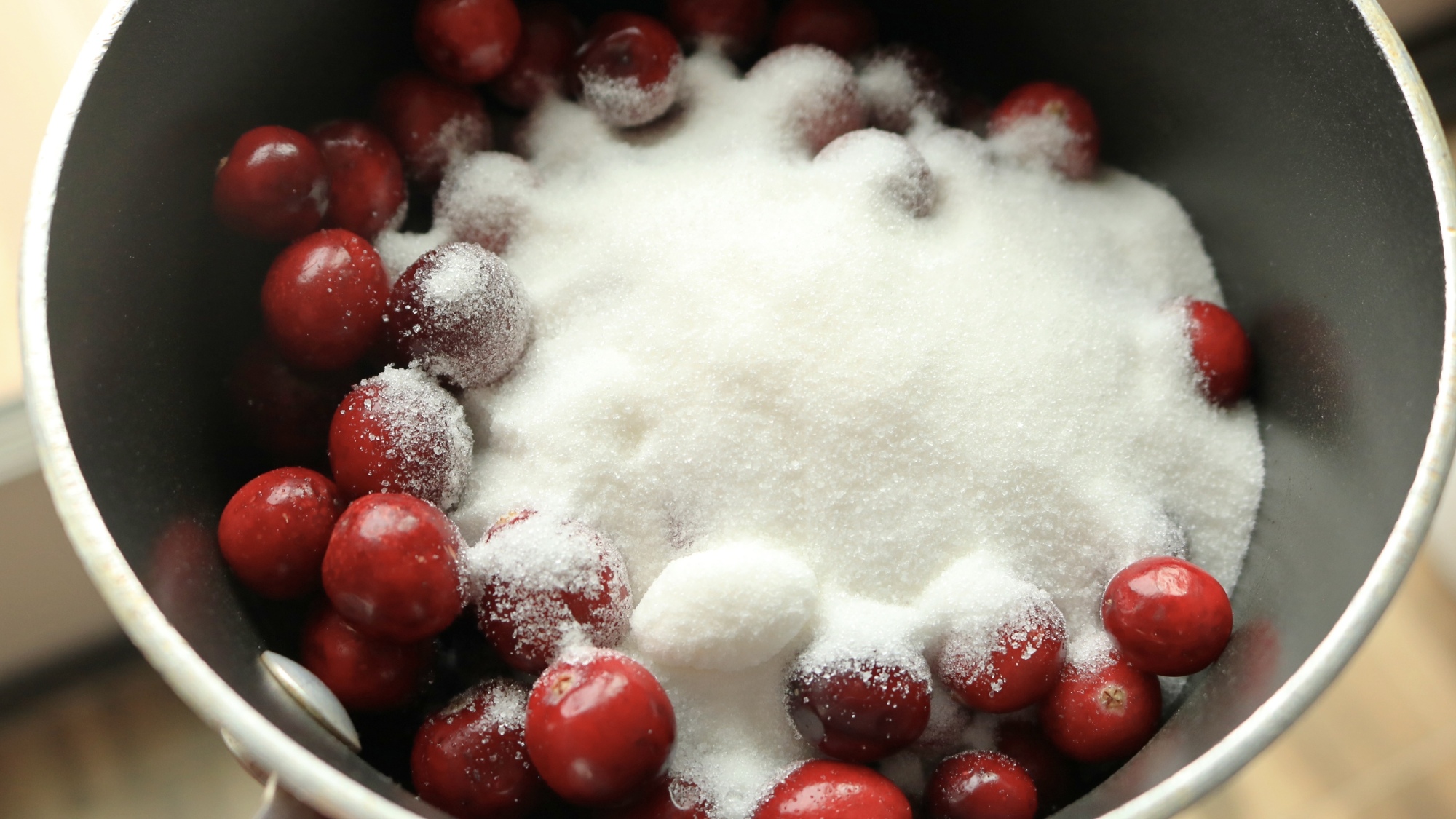 Cranberries and sugar in a pot.