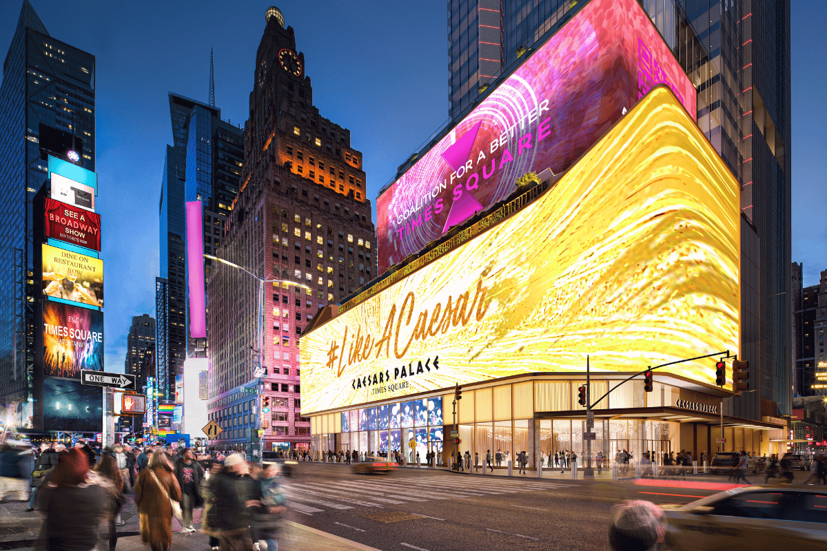 Rendering of the proposed Caesars Palace Times Square casino with large illuminated signage and crowds walking through the iconic New York City area at night.