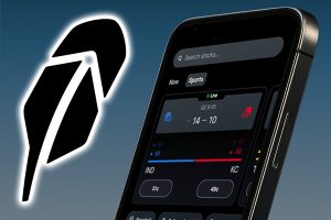 Robinhood snaps up 90% of MIAX Derivatives Exchange in prediction market push. A close-up of a smartphone displaying Robinhood’s sports prediction market interface, showing live game odds, beside a large glowing Robinhood feather logo on a blue gradient background.