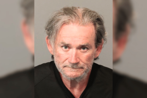 Nevada man sentenced after stealing $714K from multiple Dotty’s Casino locations. Mugshot of an older man with gray hair and light stubble, wearing a black shirt against a neutral background.